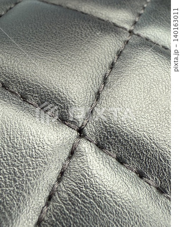 Quilted metallic leather texture with detailed stitching, perfect as luxurious fashion background Quilted metallic leather texture with detailed stitching, perfect as luxurious fashion background 140163011