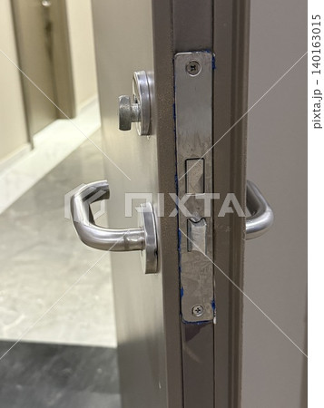 Closeup image of a metallic door latch and handle with sleek design, good for backgrounds Closeup image of a metallic door latch and handle with sleek design, good for backgrounds 140163015