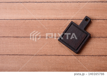Empty wooden cutting board for preparing ingredients for home cooking. An empty cutting board Empty wooden cutting board for preparing ingredients for home cooking. An empty cutting board 140165786
