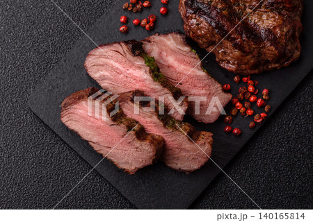 Beef mignon steak, rare, meat grilled with salt and spices. Beef steak Beef mignon steak, rare, meat grilled with salt and spices. Beef steak 140165814