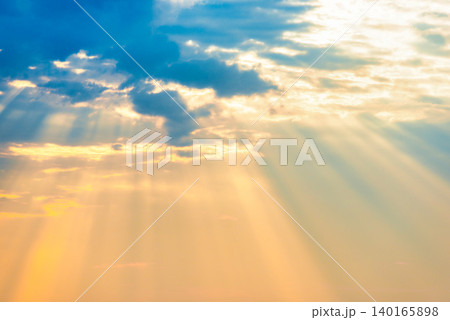 Sunset sky with sun rays through clouds 140165898