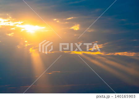 Sunset sky with sun rays through clouds Sunset sky with sun rays through clouds 140165903