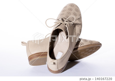 Beige women's summer shoes on a white background Beige women's summer shoes on a white background 140167220