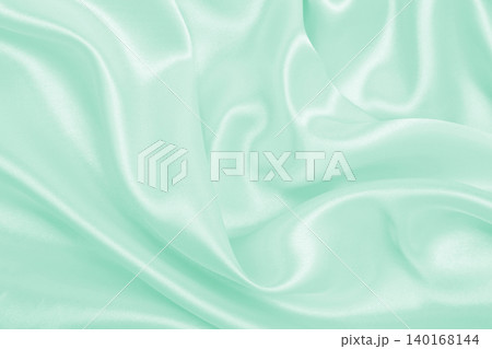 Smooth elegant green silk or satin luxury cloth texture as abstract background. Luxurious background design Smooth elegant green silk or satin luxury cloth texture as abstract background. Luxurious background design 140168144