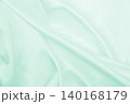 Smooth elegant green silk or satin luxury cloth texture as abstract background. Luxurious background design 140168179