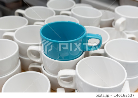 Blue cups and mugs in crockery shop, ceramic dishware, tableware stack in store Blue cups and mugs in crockery shop, ceramic dishware, tableware stack in store 140168537
