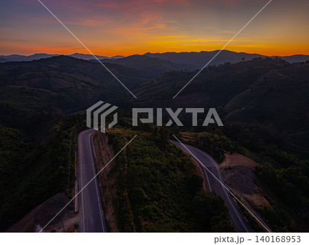 Aerial view of Twisting Mountain Road Under a Radiant Nan Sunset 140168953