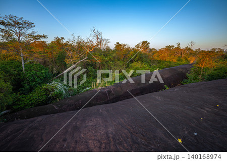 Silhouetted Travelers on Giant Sandstone Ridge 140168974