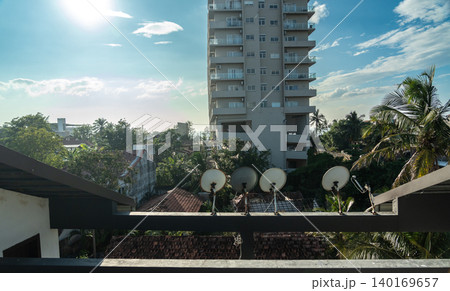 View of old tiled roofs and lush tropical greenery, editorial image View of old tiled roofs and lush tropical greenery, editorial image 140169657
