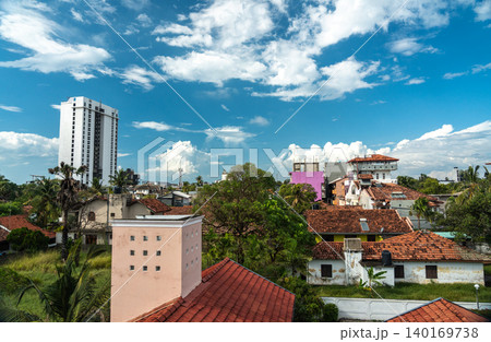 View of old tiled roofs and lush tropical greenery, editorial image 140169738