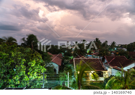 View of old tiled roofs and lush tropical greenery, editorial image View of old tiled roofs and lush tropical greenery, editorial image 140169740