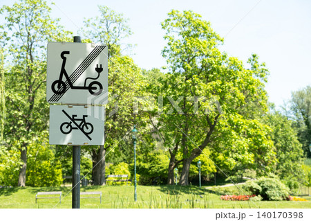 No electric scooters and no bicycles sign in a green public park No electric scooters and no bicycles sign in a green public park 140170398