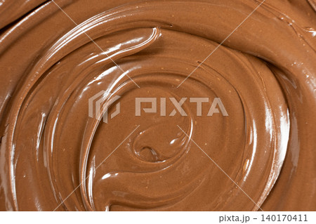 Macro texture of smooth brown chocolate nut spread swirl 140170411