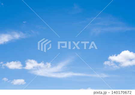 Beautiful clear blue sky background with soft white clouds and wispy streaks. Bright sunny day atmosphere perfect for nature, weather, or freedom concepts. Minimalist scenery with copy space. Beautiful clear blue sky background with soft white clouds and wispy streaks. Bright sunny day atmosphere perfect for nature, weather, or freedom concepts. Minimalist scenery with copy space. 140170672
