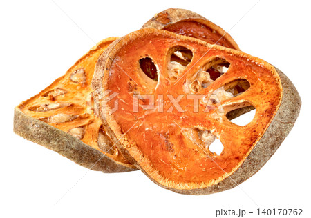 Dried bael fruit slices isolated. Aegle marmelos herbal tea ingredient known for medicinal properties and health benefits. Macro shot showing texture and seeds of wood apple. Dried bael fruit slices isolated. Aegle marmelos herbal tea ingredient known for medicinal properties and health benefits. Macro shot showing texture and seeds of wood apple. 140170762