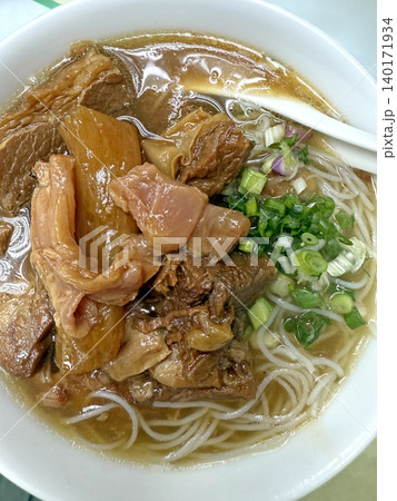 Hearty beef noodle soup with tender braised meat and fresh scallions Hearty beef noodle soup with tender braised meat and fresh scallions 140171934