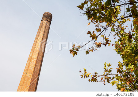 Old disabled brick chimney of a cheese factory Old disabled brick chimney of a cheese factory 140172109