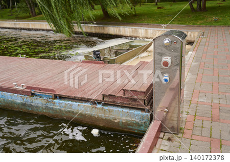 Waterfront dock with a serene view and peaceful surroundings in the park Waterfront dock with a serene view and peaceful surroundings in the park 140172378