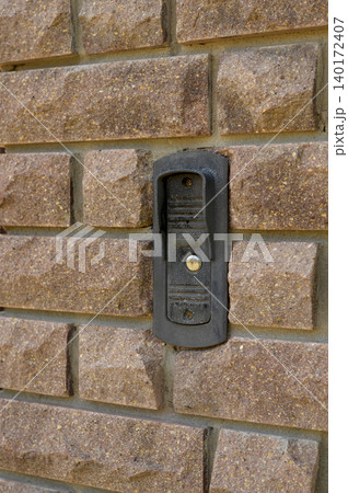 Bell mounted on a brick wall, echoing memories of home and greetings in the air Bell mounted on a brick wall, echoing memories of home and greetings in the air 140172407