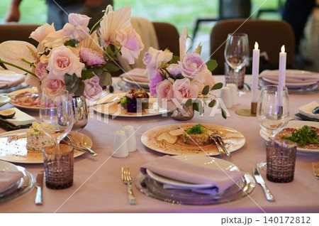 Elegant dining setting with floral arrangements Elegant dining setting with floral arrangements 140172812