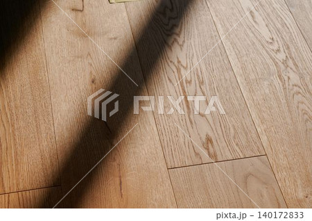 Sunlight dances on polished wooden floor Sunlight dances on polished wooden floor 140172833