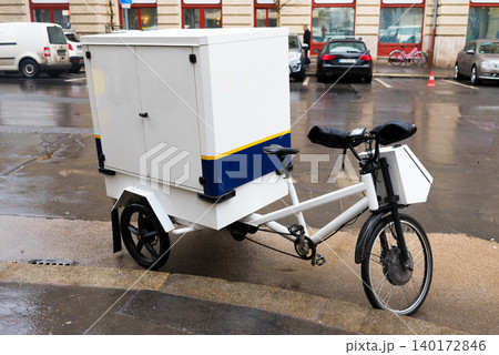 Unique cargo bicycle parked in urban setting Unique cargo bicycle parked in urban setting 140172846