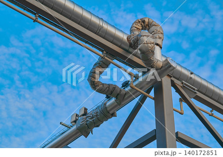Pipes twist against a vibrant blue sky Pipes twist against a vibrant blue sky 140172851
