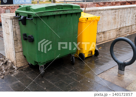 Colorful trash bins stand side by side in the city Colorful trash bins stand side by side in the city 140172857