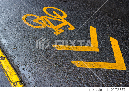 Bright yellow bike lane on a rainy day Bright yellow bike lane on a rainy day 140172871