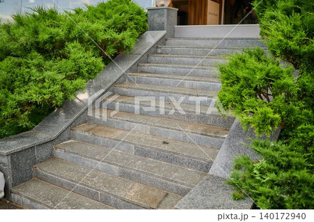 Steps leading to a serene entrance with greenery Steps leading to a serene entrance with greenery 140172940