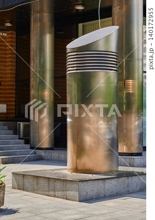Modern metallic sculpture graces urban plaza 140172955