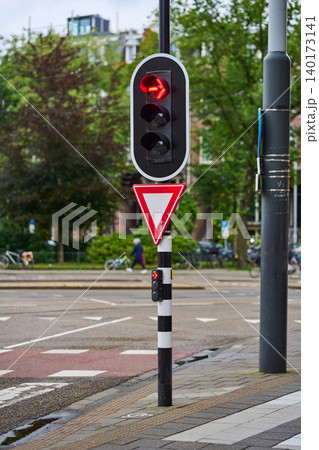 Traffic Signals Guiding Pedestrians and Cyclists in Bustling Amsterdam City Center During a Vibrant Day 140173141