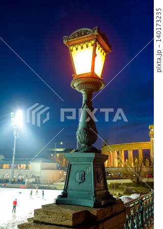 Winter night skating under glowing street lamps 140173235