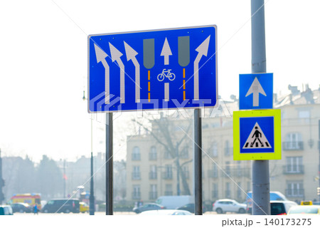 Road signs guide cyclists through busy city lane 140173275