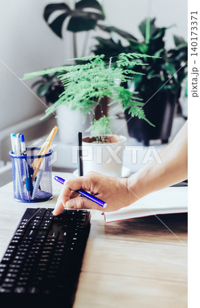 A man types on a keyboard and works with financial data A man types on a keyboard and works with financial data 140173371