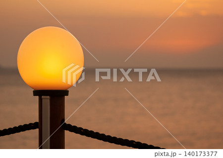 light bulb on from an Ibiza pub at sunset light bulb on from an Ibiza pub at sunset 140173377