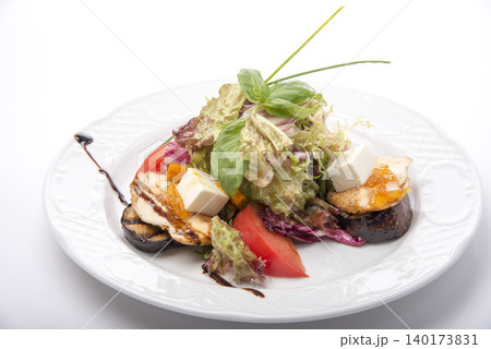 Delicious grilled chicken salad with fresh vegetables and a hint of balsamic glaze in bright plating Delicious grilled chicken salad with fresh vegetables and a hint of balsamic glaze in bright plating 140173831