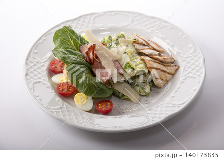 Fresh and vibrant salad with grilled chicken and creamy dressing served elegantly on a plate 140173835