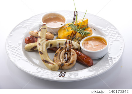 Flavorful assortment of grilled sausages and tropical sides served with rich sauces Flavorful assortment of grilled sausages and tropical sides served with rich sauces 140173842