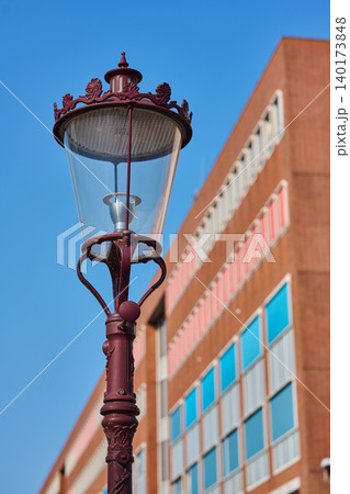 Vintage Streetlamp Stands Proud Against Modern Architecture in the Heart of Amsterdam City Center During a Bright Sunny Day Vintage Streetlamp Stands Proud Against Modern Architecture in the Heart of Amsterdam City Center During a Bright Sunny Day 140173848