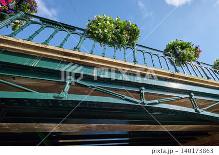 Colorful Flowers Draping the Charming Bridge in Amsterdam's Vibrant City Center on a Sunny Day 140173863