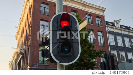Traffic Light Signaling Stop at Sunset in Vibrant Amsterdam City Center Capturing the Essence of Urban Life 140173905