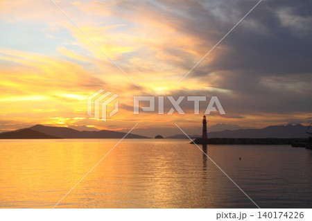 Seascape at sunshine. Lighthouse and sailings on the coast. Seaside town of Turgutreis and spectacular sunshine Seascape at sunshine. Lighthouse and sailings on the coast. Seaside town of Turgutreis and spectacular sunshine 140174226