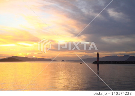 Seascape at sunshine. Lighthouse and sailings on the coast. Seaside town of Turgutreis and spectacular sunshine Seascape at sunshine. Lighthouse and sailings on the coast. Seaside town of Turgutreis and spectacular sunshine 140174228