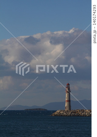 Seascape at sunshine. Lighthouse and sailings on the coast. Seaside town of Turgutreis and spectacular sunshine 140174293