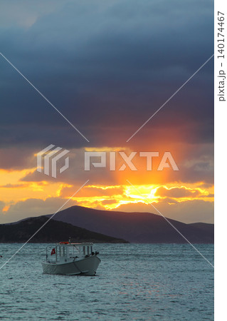 Alone sailboat at sunset. Atmospheric seascape with reflection 140174467