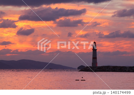 Seascape at sunshine. Lighthouse and sailings on the coast. Seaside town of Turgutreis and spectacular sunshine 140174499