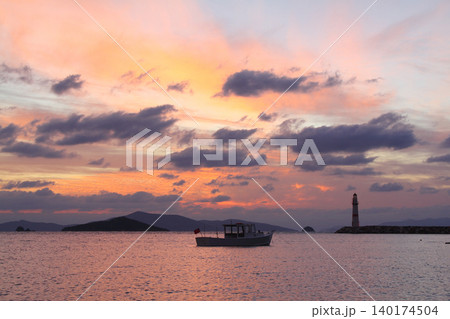 Seascape at sunshine. Lighthouse and sailings on the coast. Seaside town of Turgutreis and spectacular sunshine Seascape at sunshine. Lighthouse and sailings on the coast. Seaside town of Turgutreis and spectacular sunshine 140174504