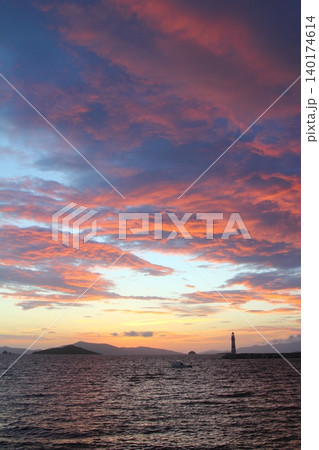 Seascape at sunshine. Lighthouse and sailings on the coast. Seaside town of Turgutreis and spectacular sunshine Seascape at sunshine. Lighthouse and sailings on the coast. Seaside town of Turgutreis and spectacular sunshine 140174614