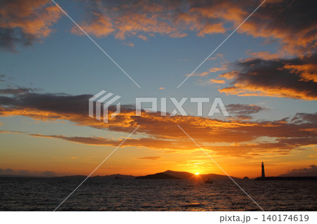 Seascape at sunshine. Lighthouse and sailings on the coast. Seaside town of Turgutreis and spectacular sunshine Seascape at sunshine. Lighthouse and sailings on the coast. Seaside town of Turgutreis and spectacular sunshine 140174619